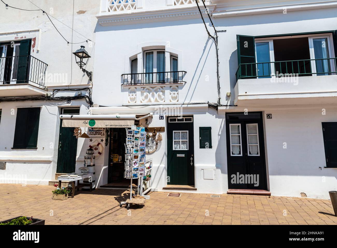 Fornells, Spain - July 21, 2021: Street of the fishing village of Fornells on summer in Menorca, Balearic island, Spain Stock Photo