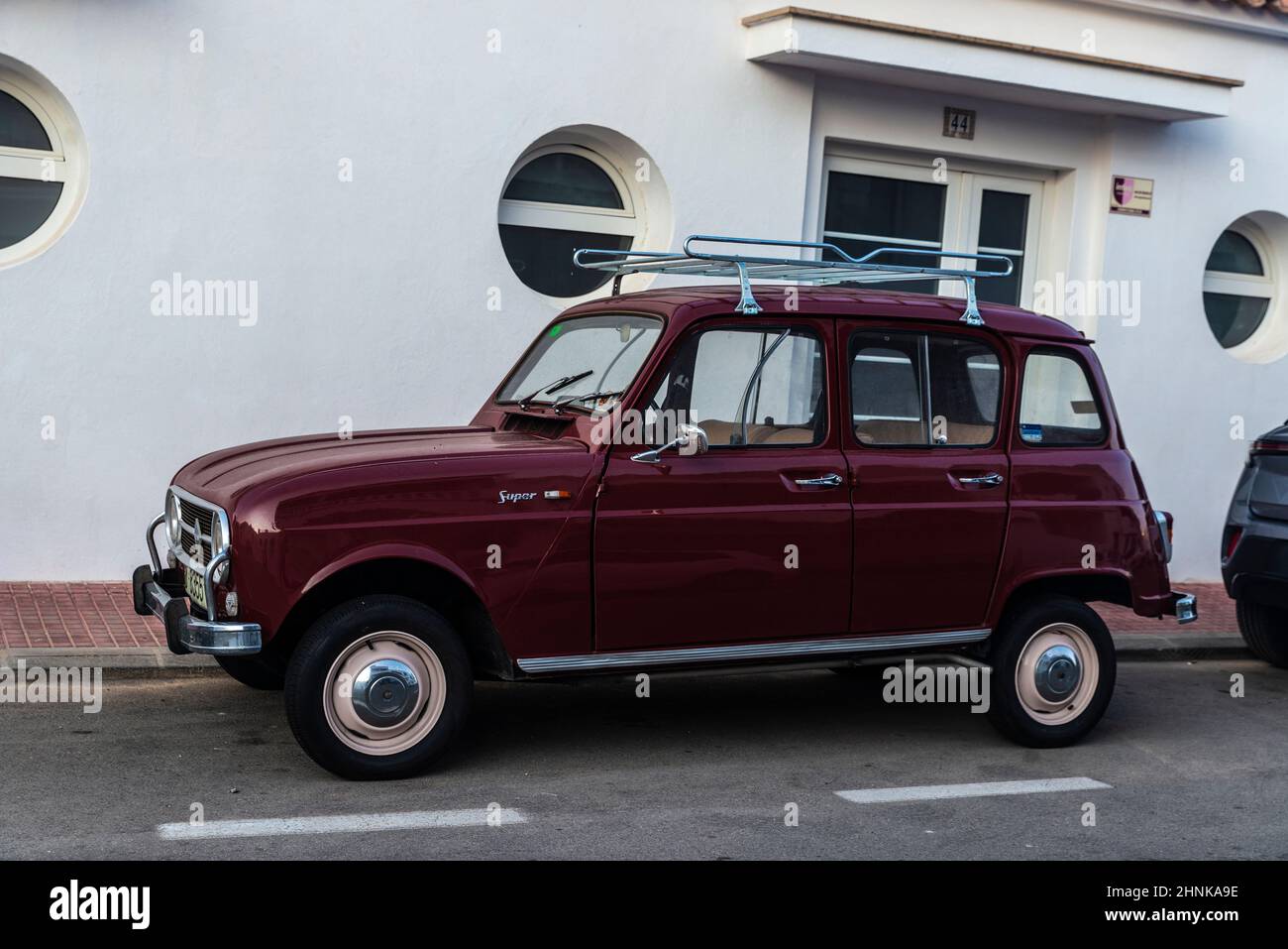 Fornells, Spain - July 20, 2021: Garnet Renault 4 Super car with roof rack parked on a street in Fornells, Menorca, Balearic island, Spain Stock Photo