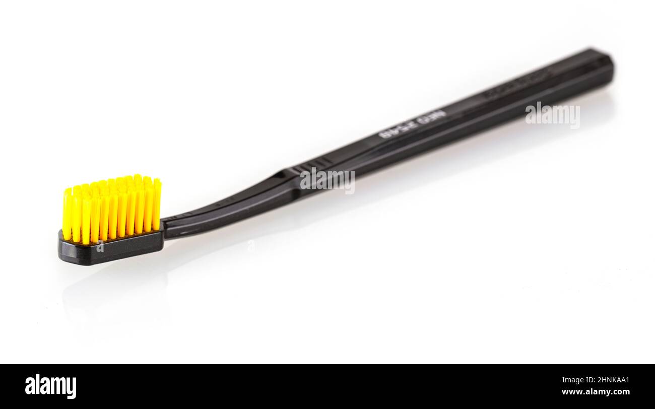 black toothbrush with yellow bristles  isolated on white Stock Photo
