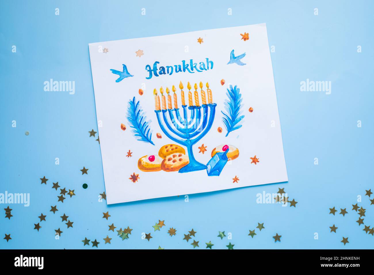 Hanukkah symbols flat lay.  Traditional jewish holiday greeting card design with happy hanukkah congratulations. Menorah with david star, pitta bread Stock Photo