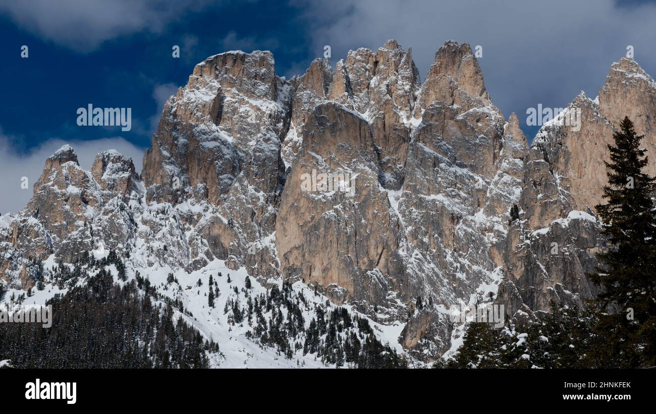 The idyllic panorama of the snowy forest and peaks in the Dolomiti. Stock Photo