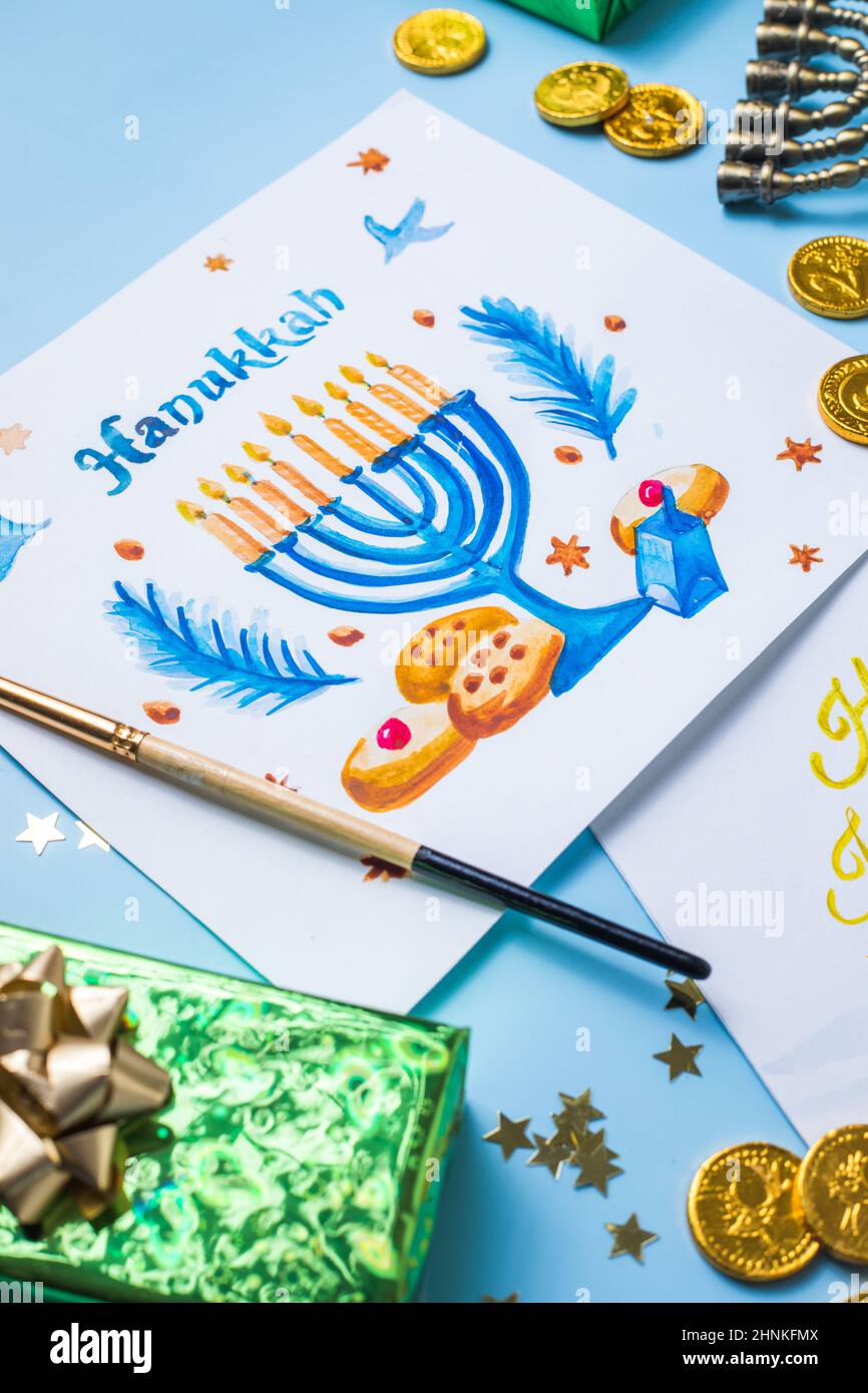 Hanukkah symbols flat lay.  Traditional jewish holiday greeting card design with happy hanukkah congratulations. Menorah with david star, pitta bread Stock Photo