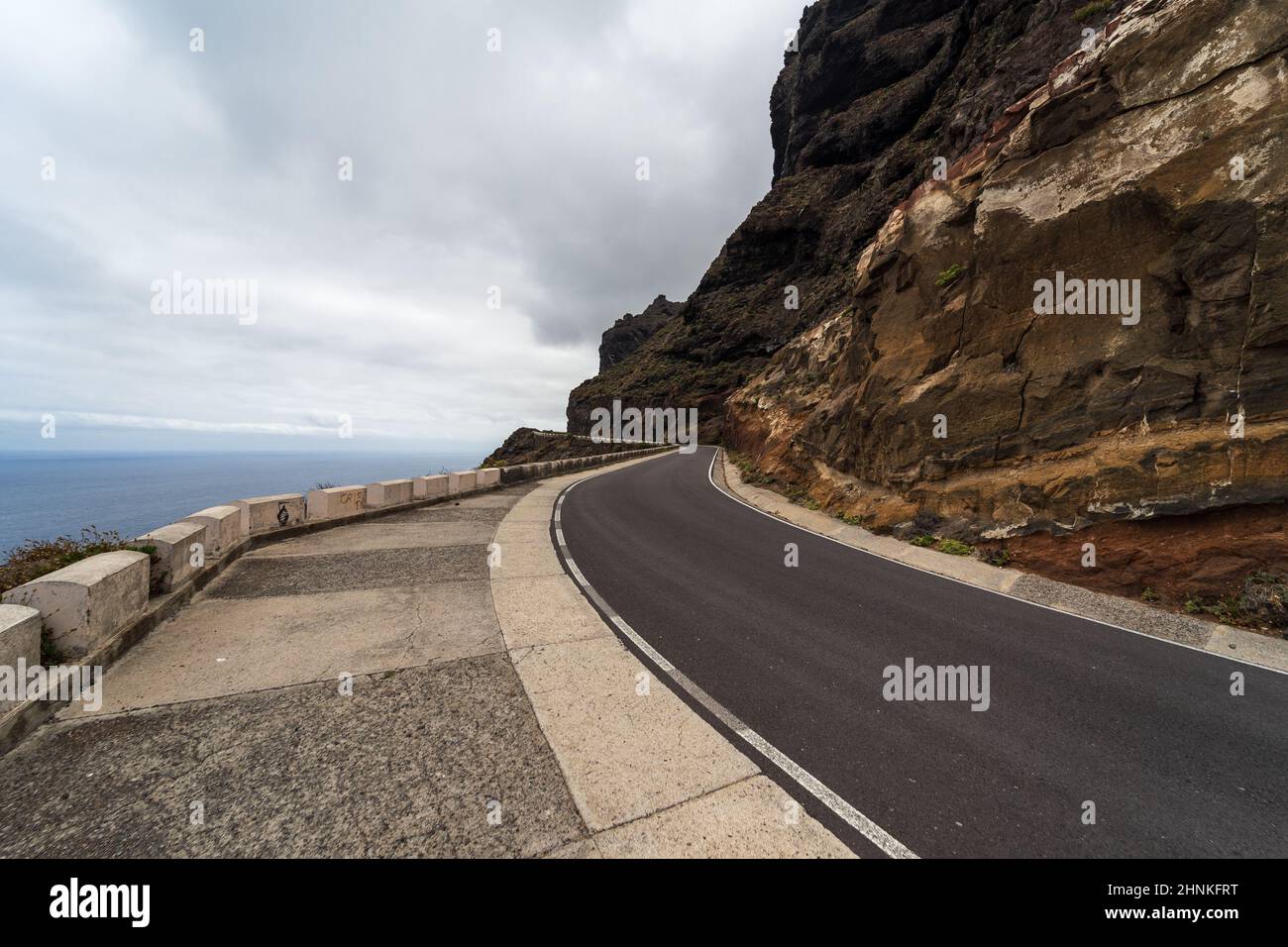 High mountain road at the edge of the ocean. Stock Photo