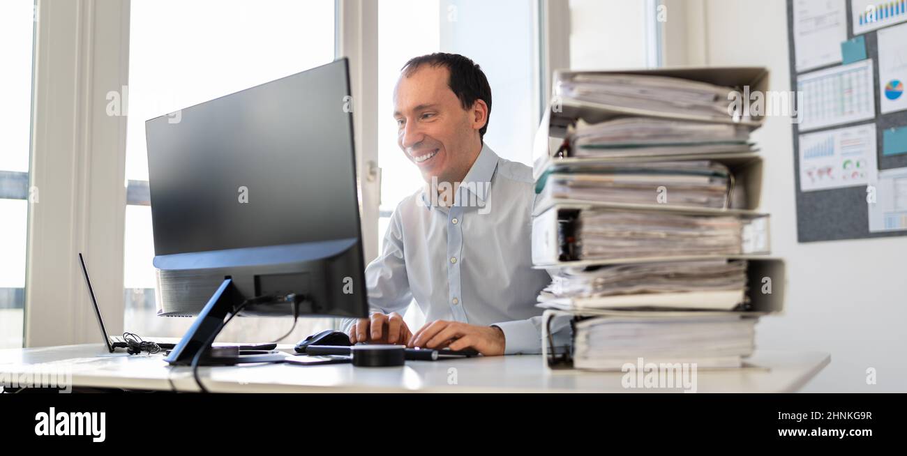 Accountant With Folders Paper Stack Doing Invoice Audit Stock Photo