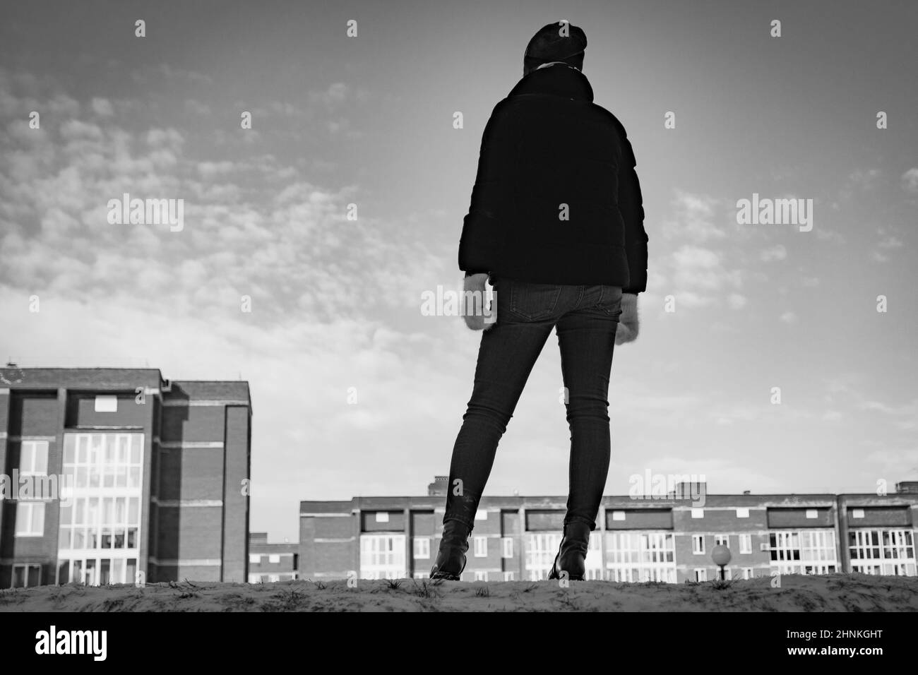 Woman stays on the city background black and white Stock Photo