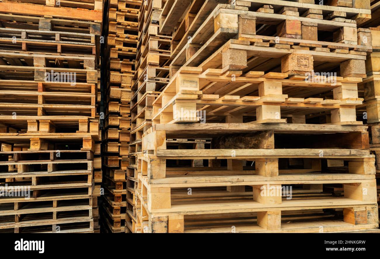 Stack of wooden pallet. Industrial wood pallet at factory warehouse. Cargo and shipping concept. Sustainability of supply chains. Eco-friendly nature and sustainable properties. Renewable wood pallet. Stock Photo