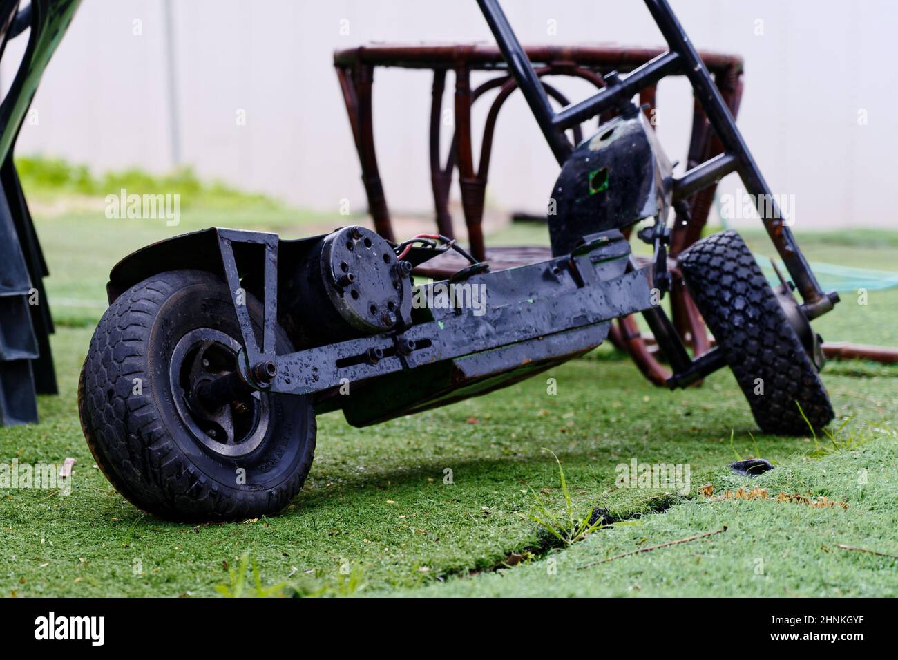 Black electric scooter on the grass close-up Stock Photo