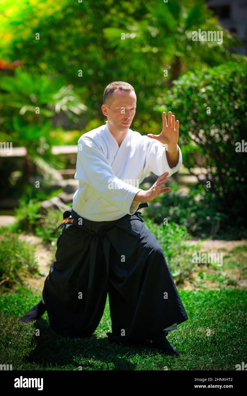 Young serious man aikido master in traditional costume Stock Photo