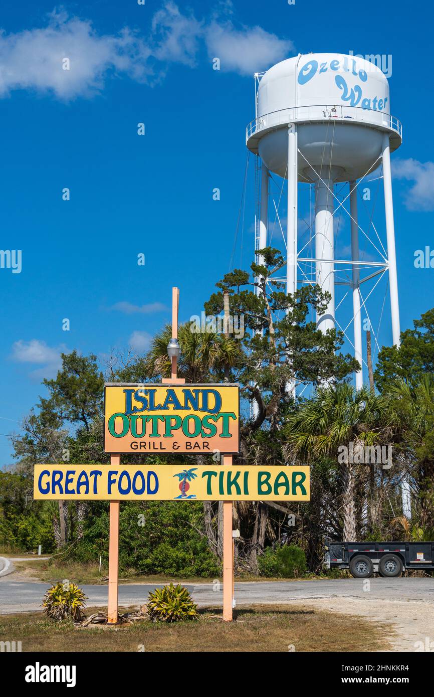 Island Outpost Grill and Bar sign and Ozello water tower, vertical shot - Crystal River, Florida, USA Stock Photo