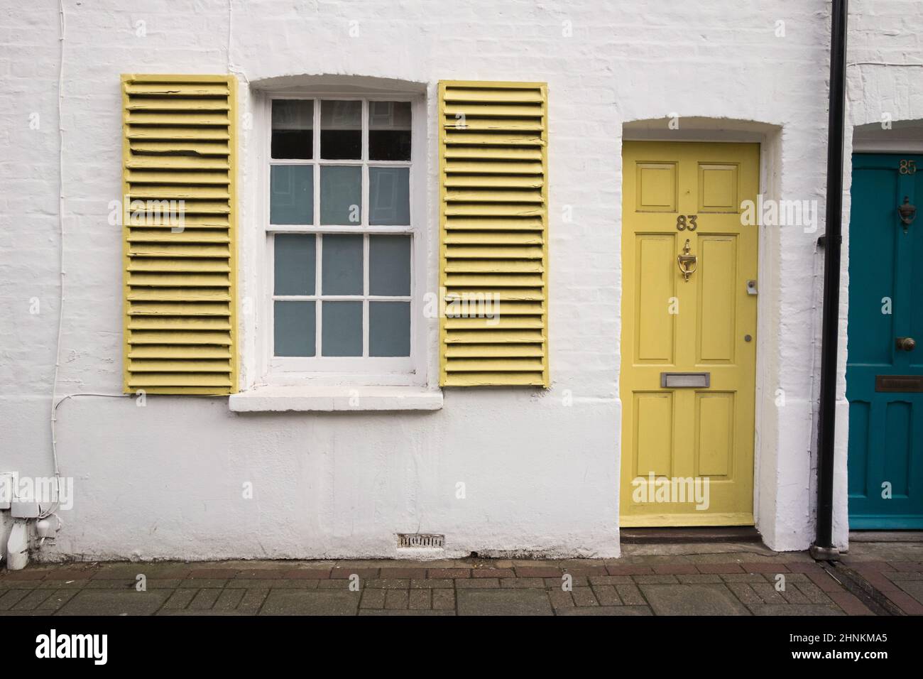 Colourful front doors and window shutters on terraced housing, Sheen Lane, London, England, UK Stock Photo