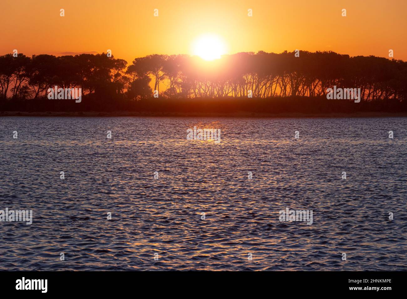 Salento coast: view at sunset of harbor of Porto Cesareo in Apulia, Italy. In the background the Island of the Rabbits. Stock Photo
