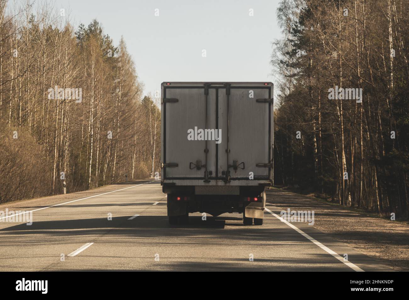 Delivery truck driving on a highway. car moving on a roadway Stock Photo