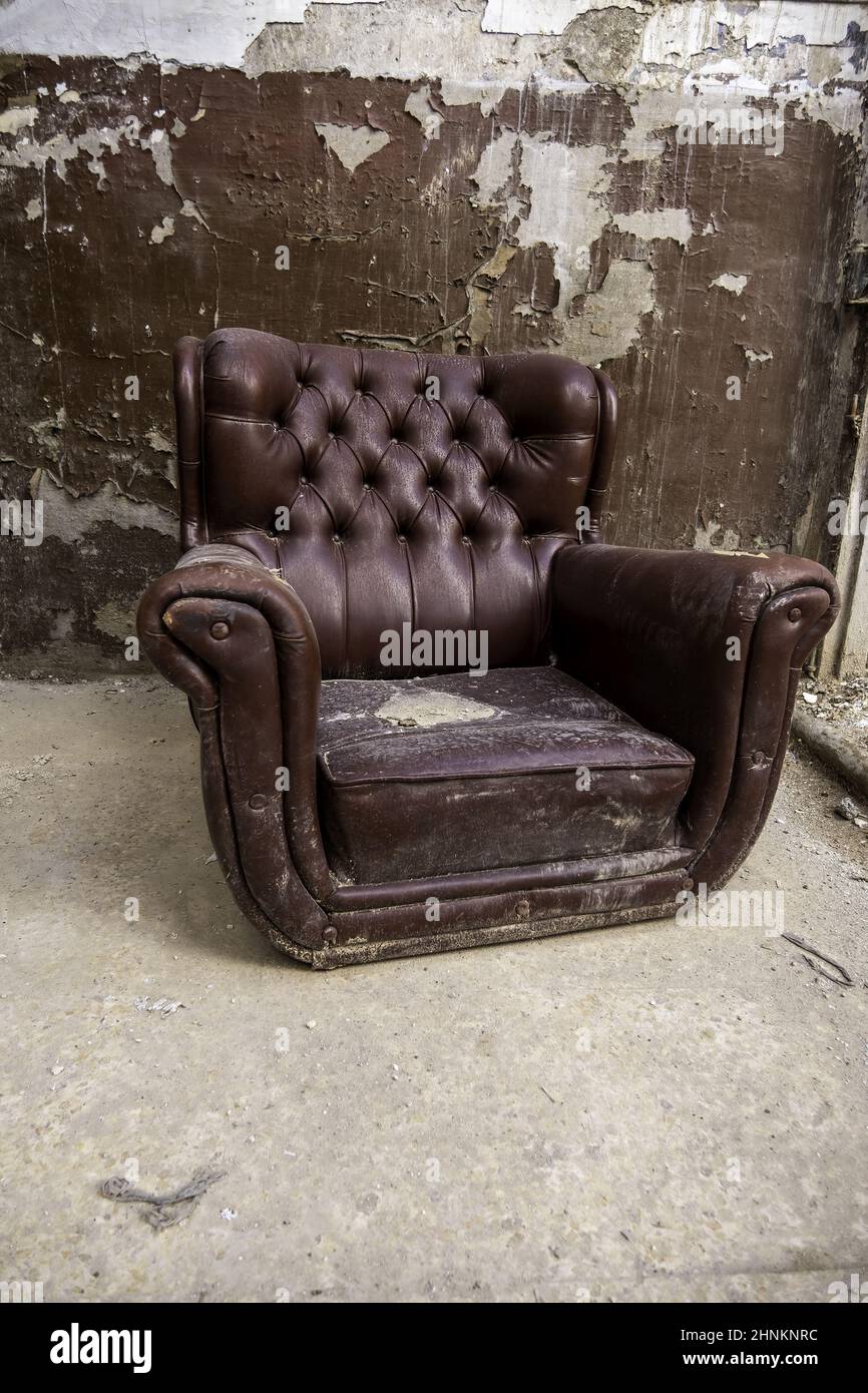 Old abandoned leather armchair Stock Photo