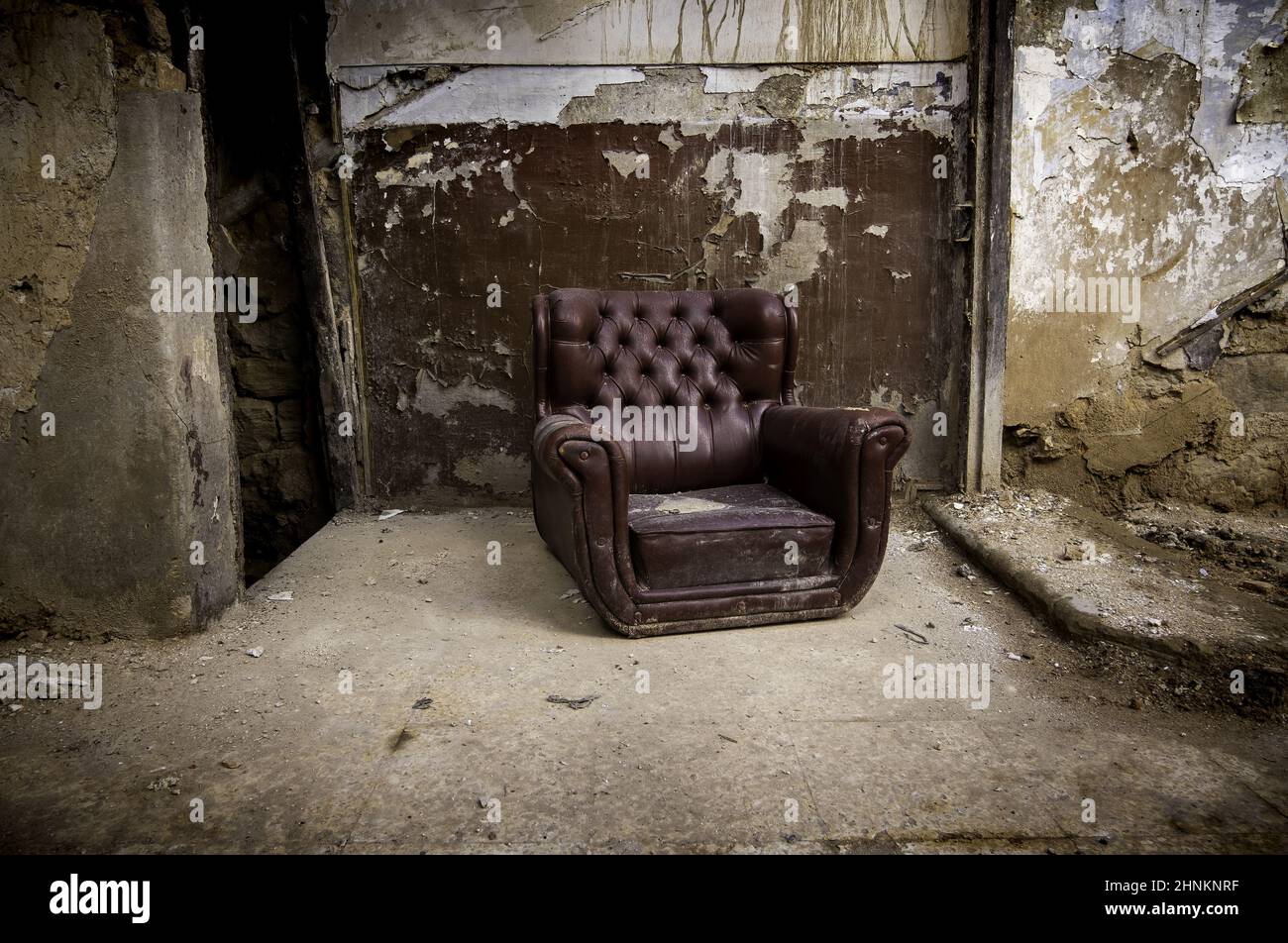 Old abandoned leather armchair Stock Photo