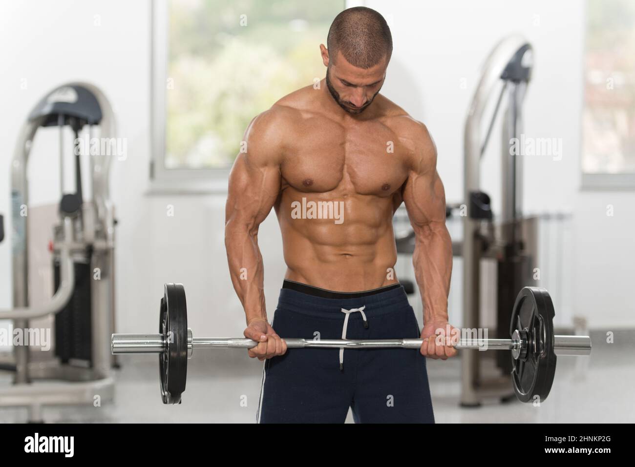 Biceps Exercise With Barbell Stock Photo - Alamy