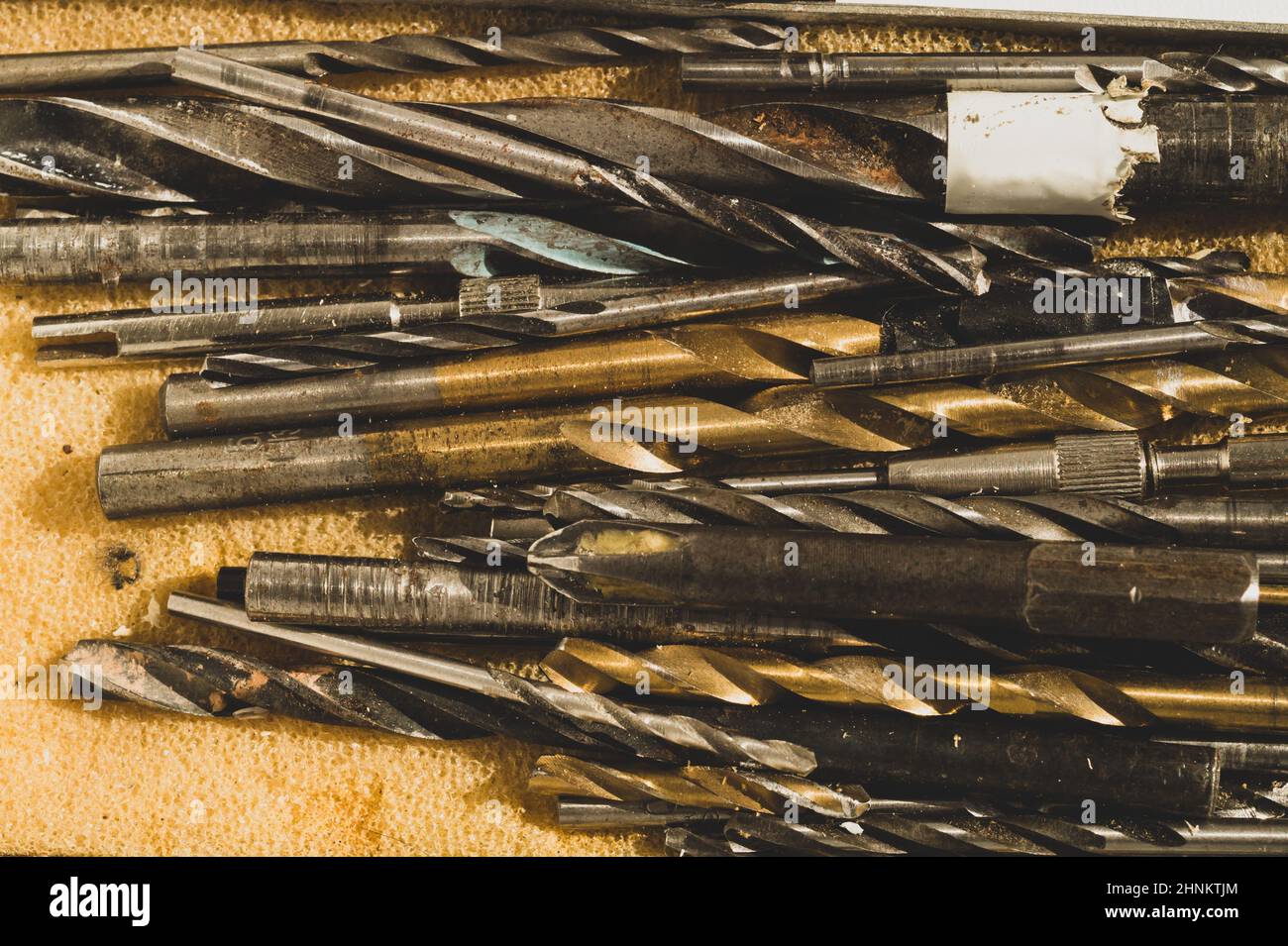 Different drills in a box. pile of drill bits in a case. work tools