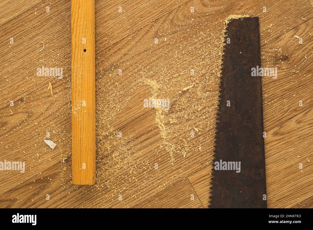 Old hand saw on a wooden background. working area with hand instrument. carpentry instrument. manual labor concept Stock Photo