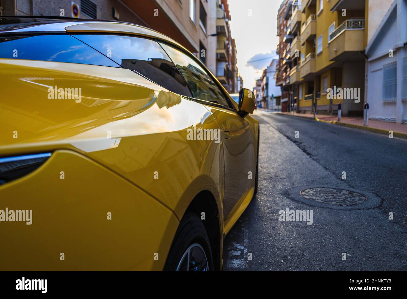 yellow sports car parked on the street of the Alicante Stock Photo Alamy