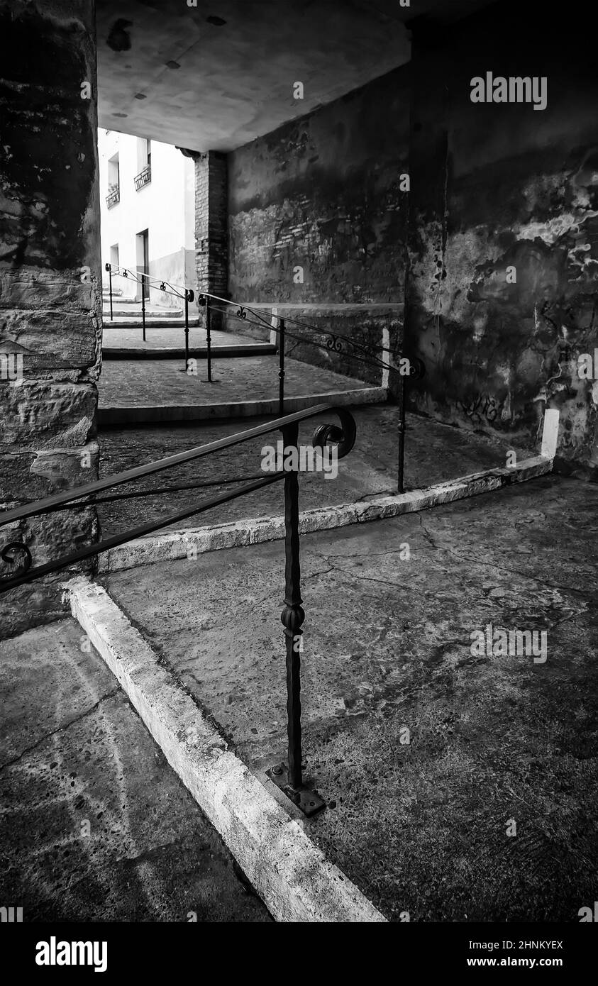 Old stairs with wrought iron railing Stock Photo