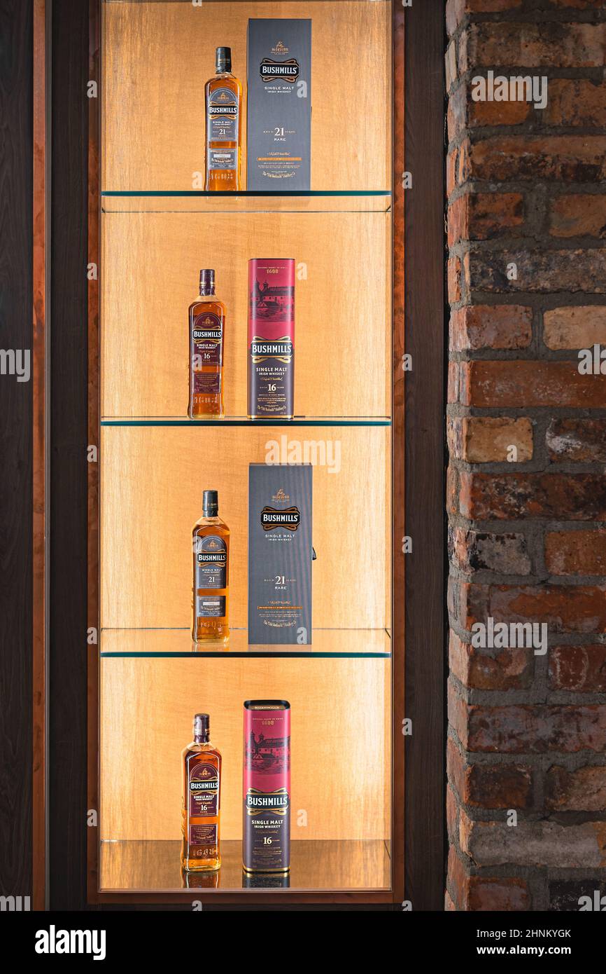 Selection of aged 16 and 21 years Bushmills whiskey with a boxes on illuminated display in distillery shop Stock Photo