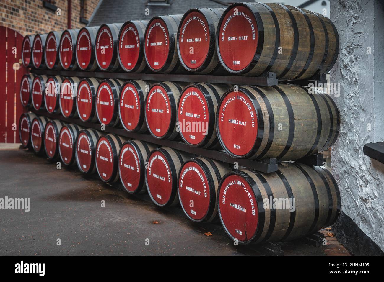 Rows of maturing whiskey casks in a traditional warehouse at the Old Bushmills Distillery, Bushmills