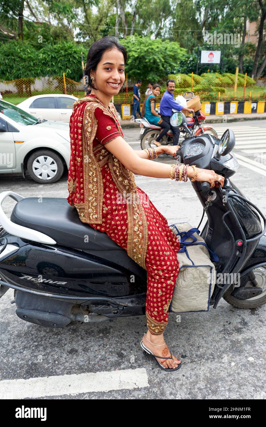 India Rajasthan Udaipur. A beautiful smiling girl on a scooter Stock Photo