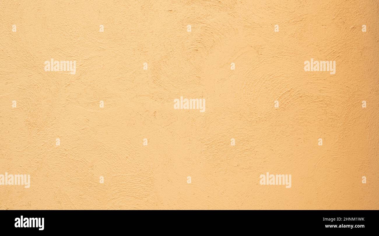 Yellow orange Beige painted stucco wall construction. Pattern Background texture. Stock Photo