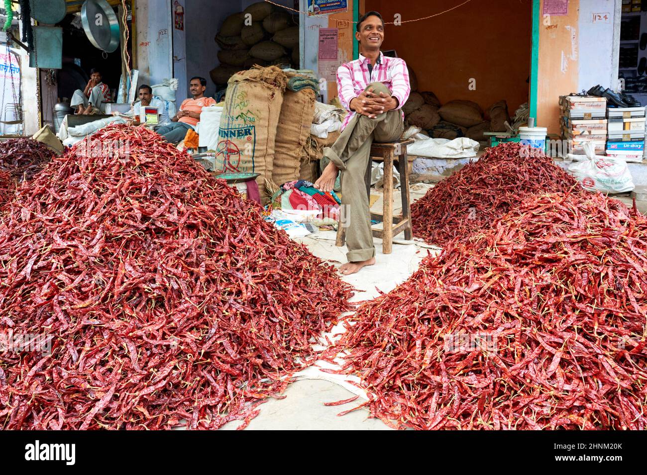 India Rajasthan Bundi. Man selling dried chili at the market Stock Photo