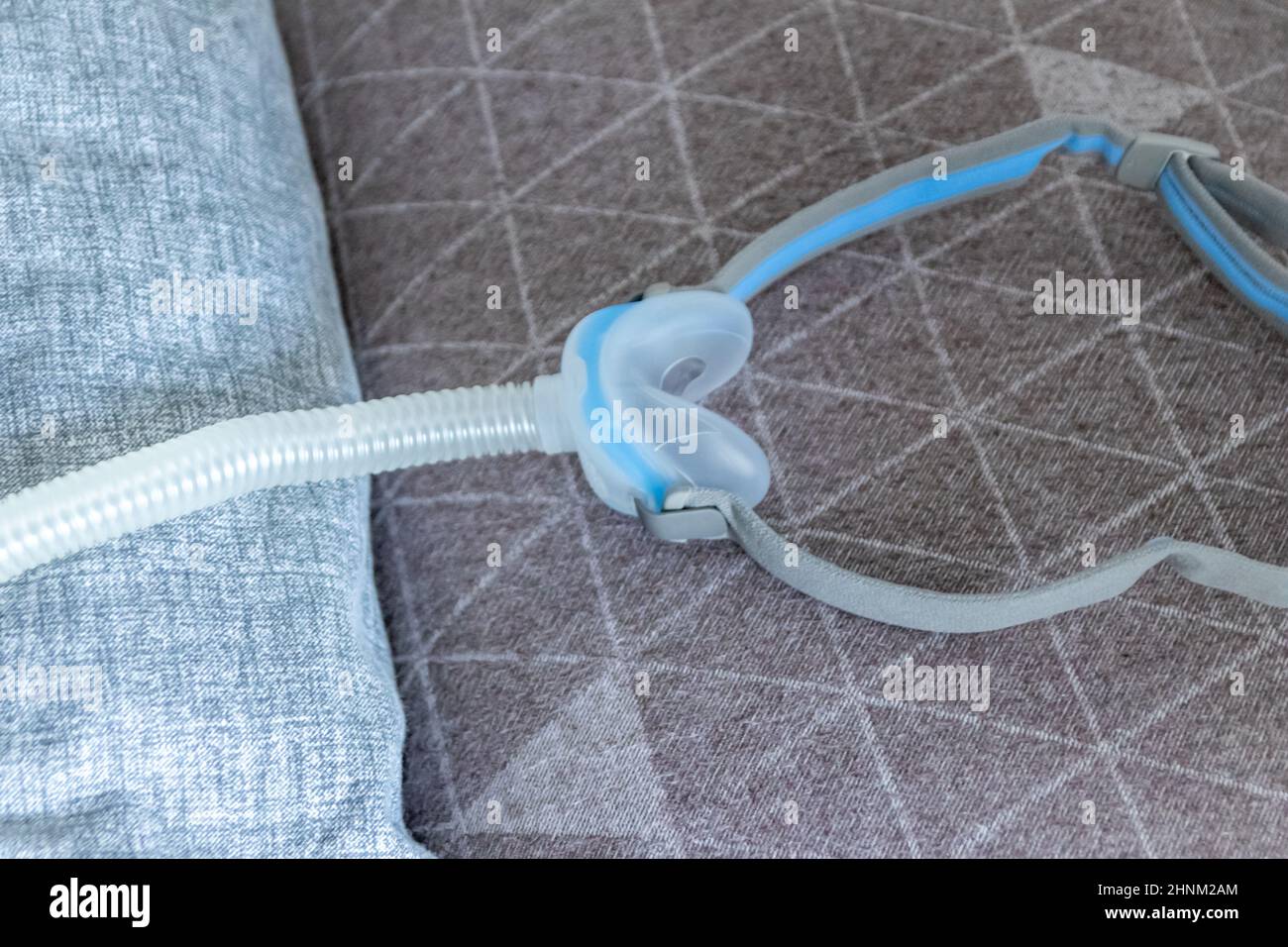 CPAP mask against obstructive sleep apnea helps patients respirator mask headgear clip for nose and throat breathing medication with cpap machine against snoring and sleep disorder to breath easier Stock Photo