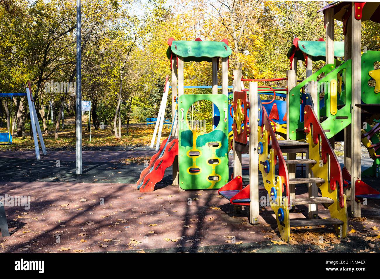 colorful wooden slides and houses on playground Stock Photo