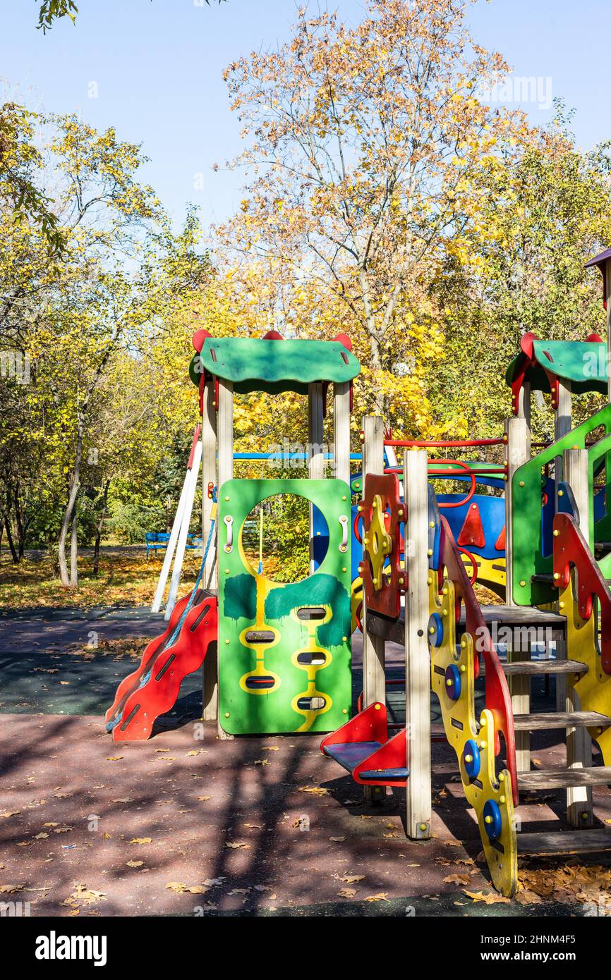colorful wooden rides, slides on playground Stock Photo