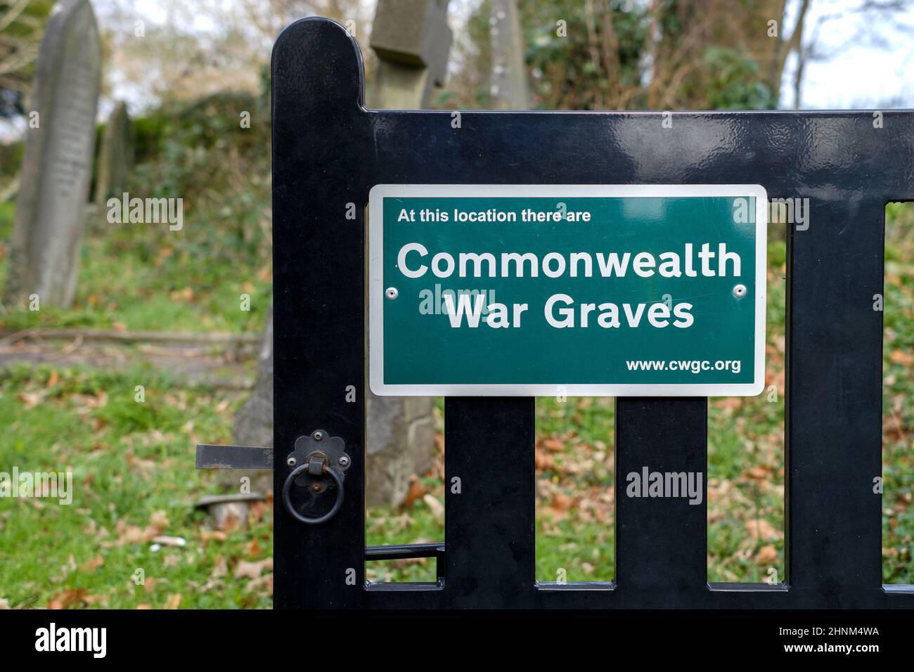 A sign on a church cemetery gate showing that there are Commonwealth war graves located within the cemetery Stock Photo