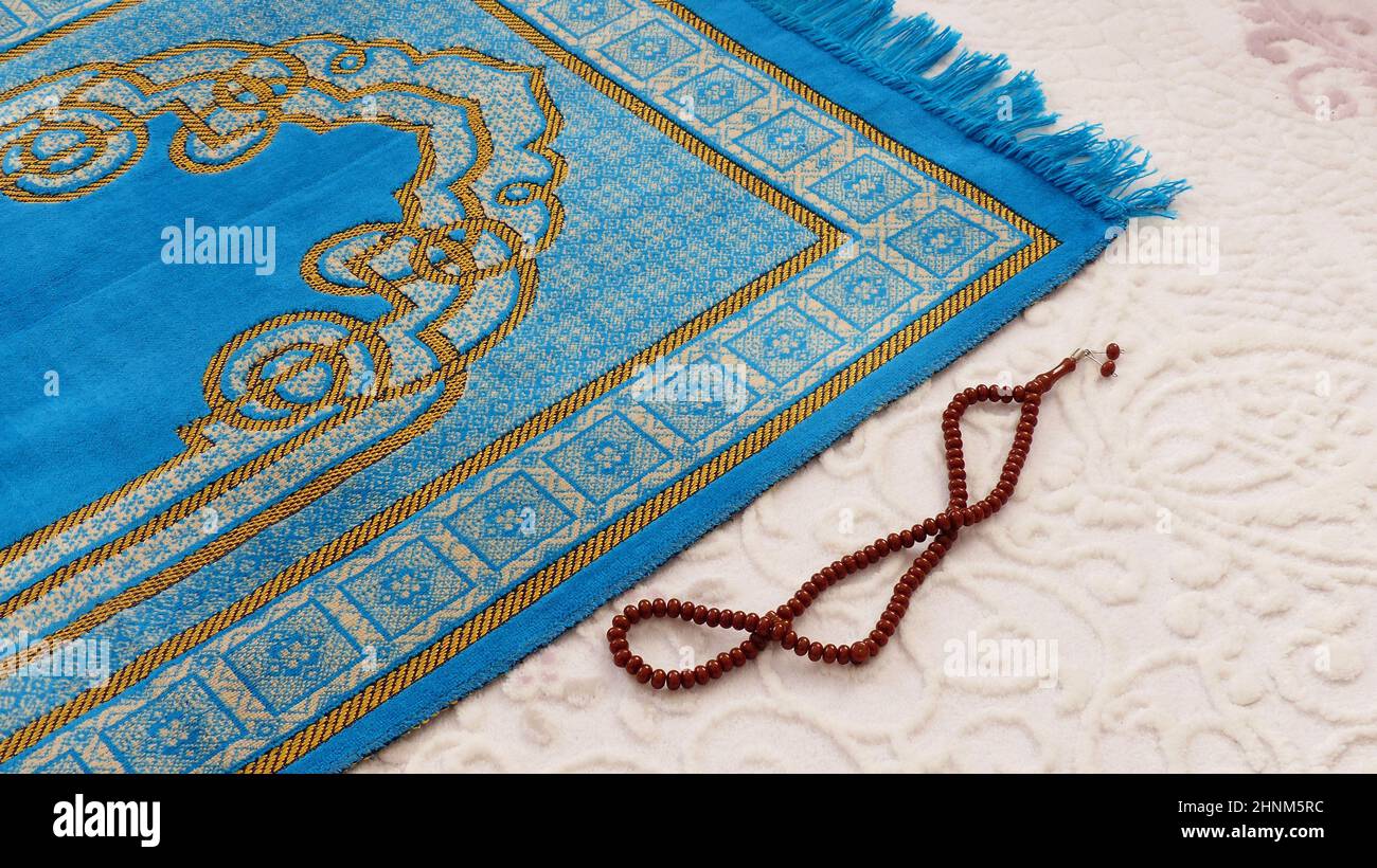 prayer rug and rosary, blue prayer carpet used for praying in Islam