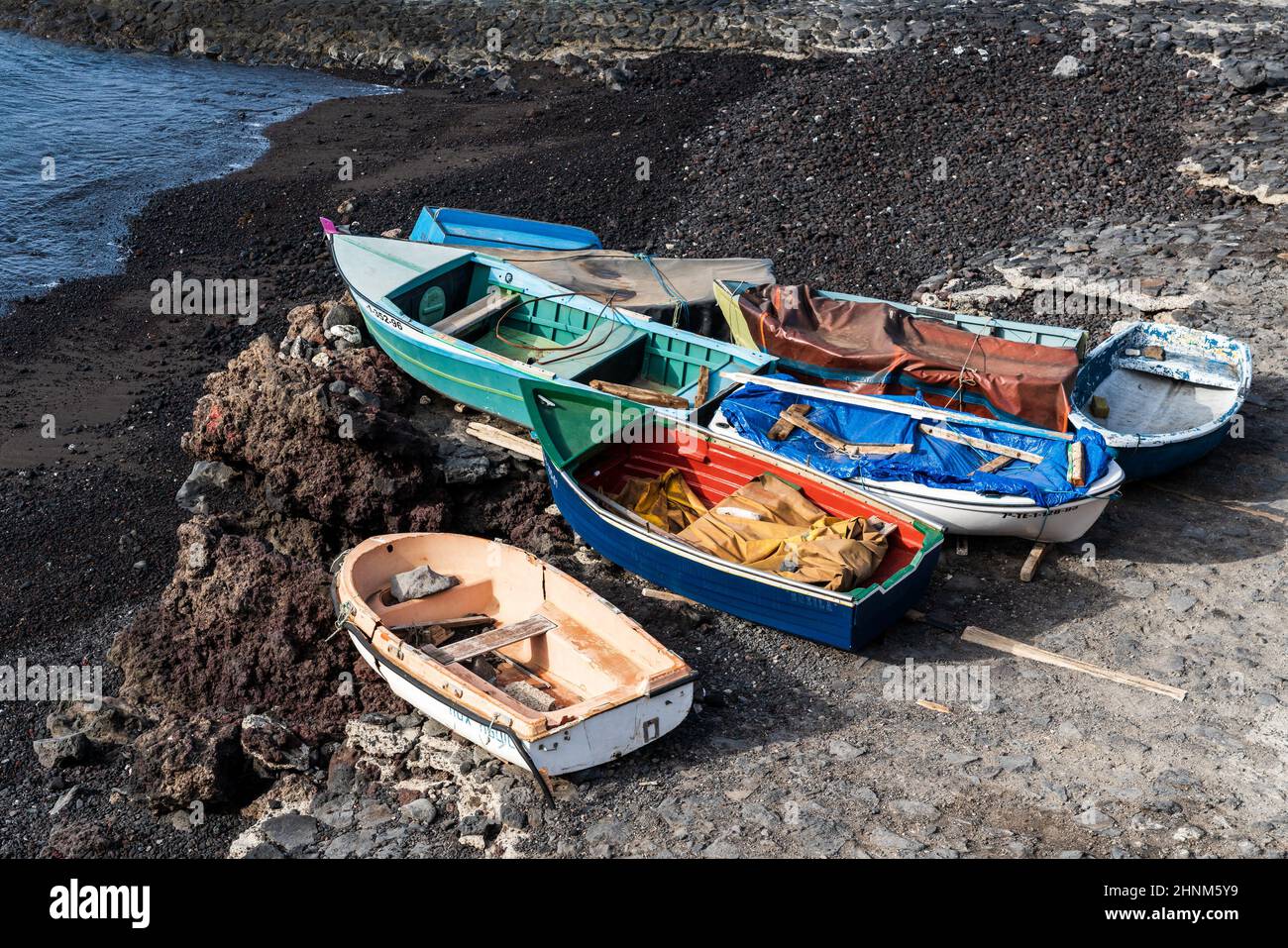 Wooden boats on the shore of the ocean Stock Photo - Alamy