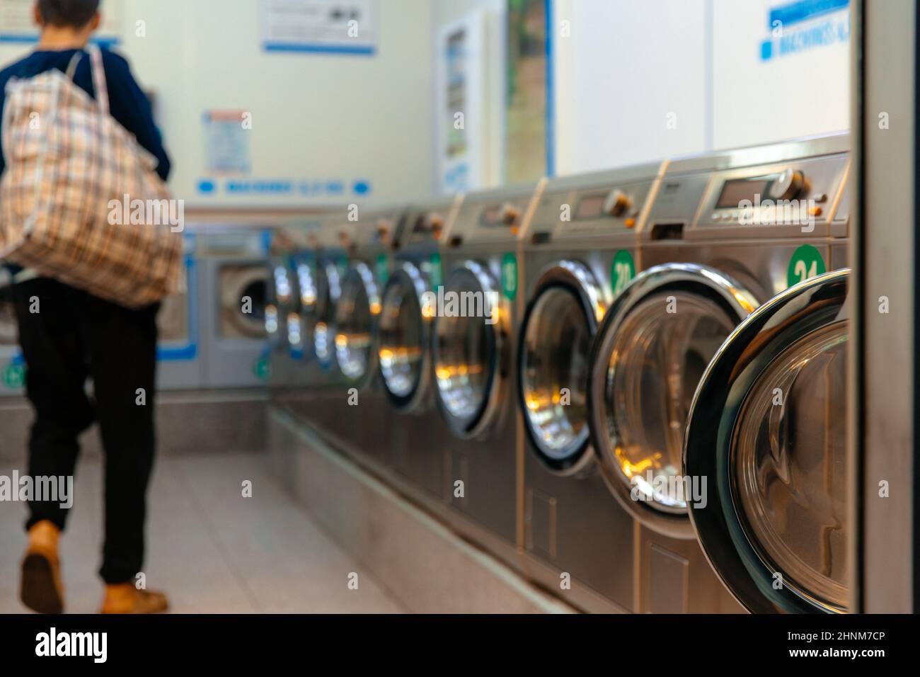 Iaundry machines in laundromat. Stock Photo