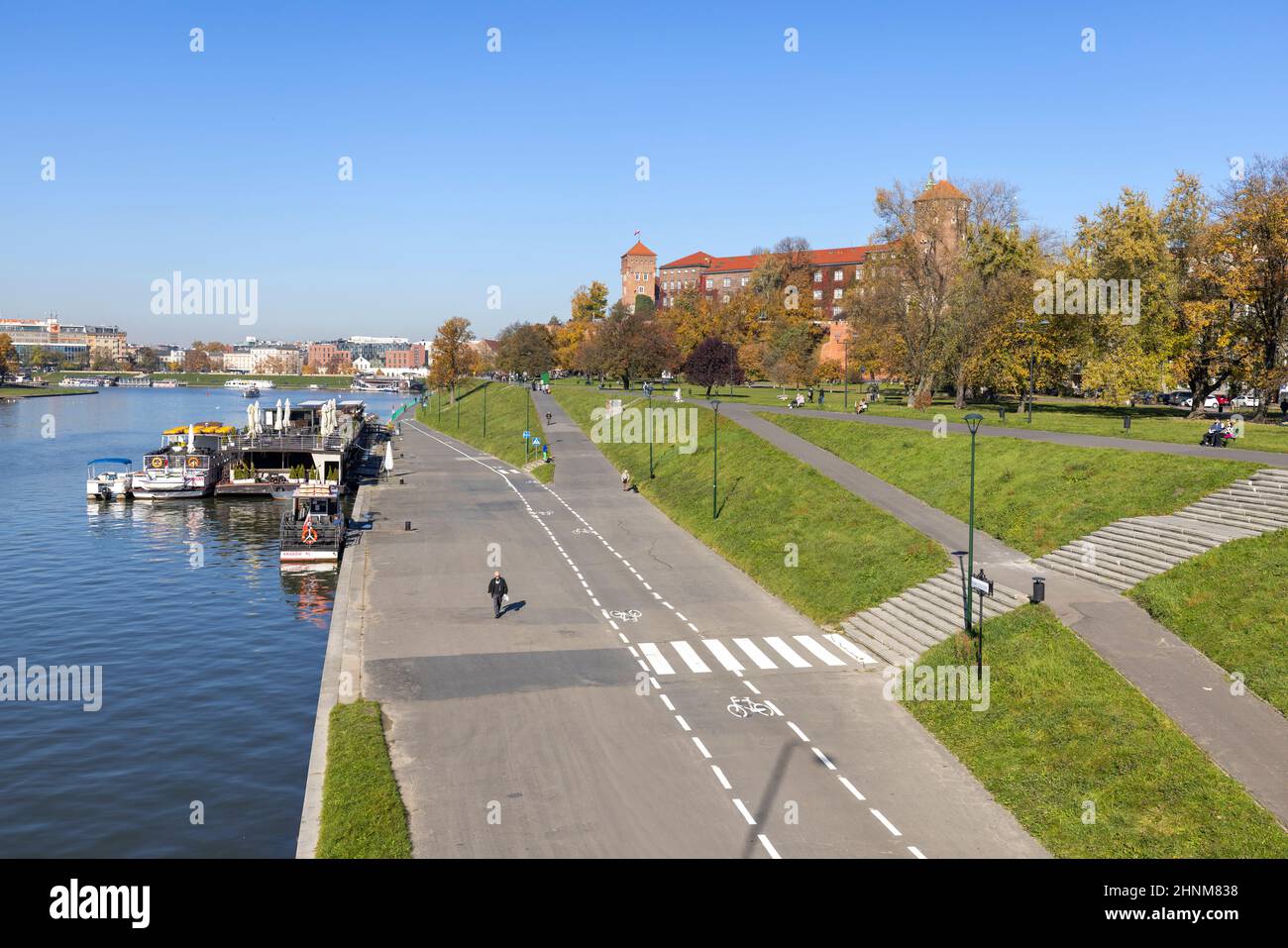 Boulevards on the river Wisla, Wawel Royal Castle among trees in autumn colors, Krakow, Poland Stock Photo