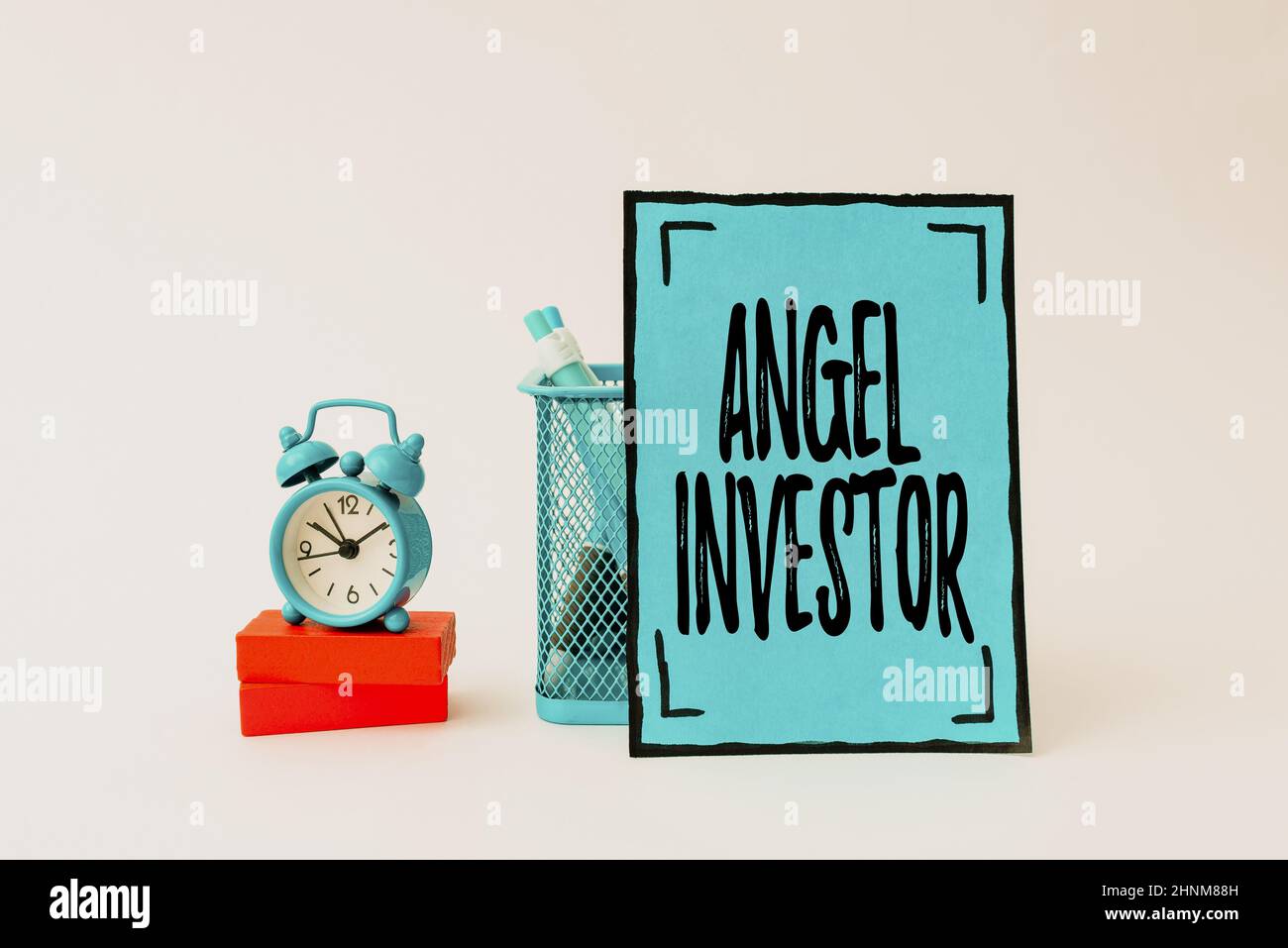 Text showing inspiration Angel Investor, Word for high net worth individual who provides financial backing Tidy Workspace Setup Writing Desk Tools And Stock Photo