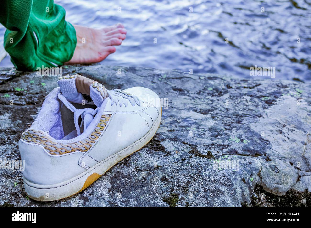 Pulled off sports shoe by the river, Norway. Stock Photo