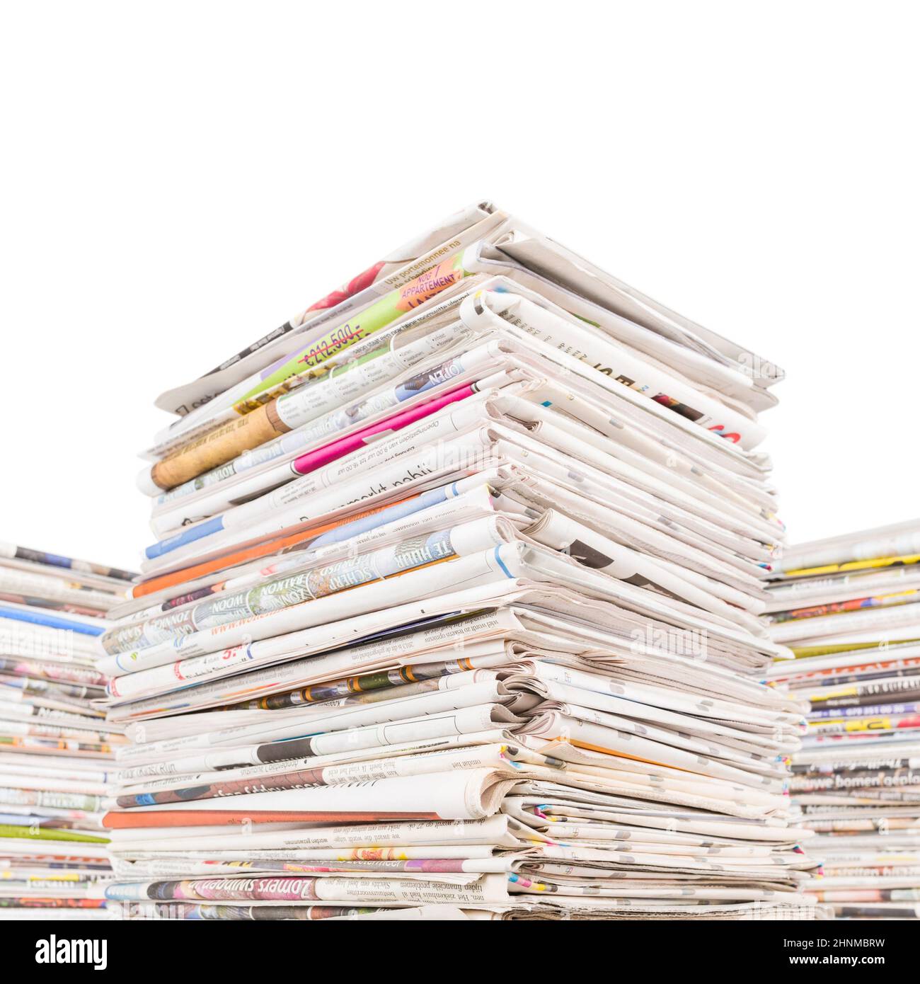 Three big stacks of newspapers Stock Photo