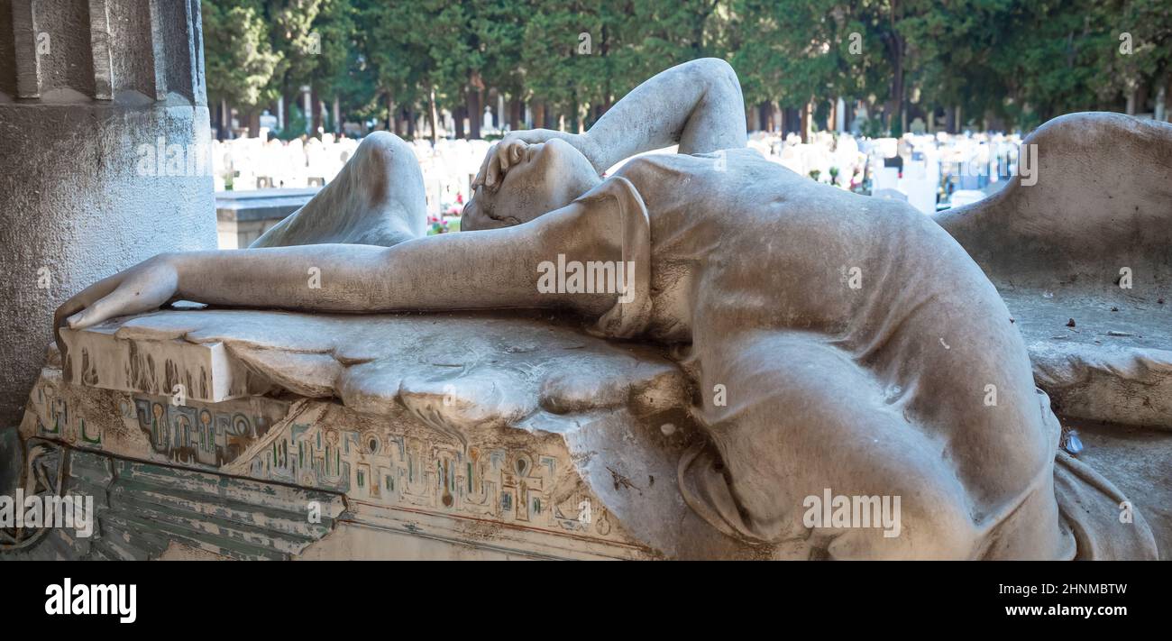 Statue of angel on a 1910 tomb located in an old Italian cemetery Stock Photo