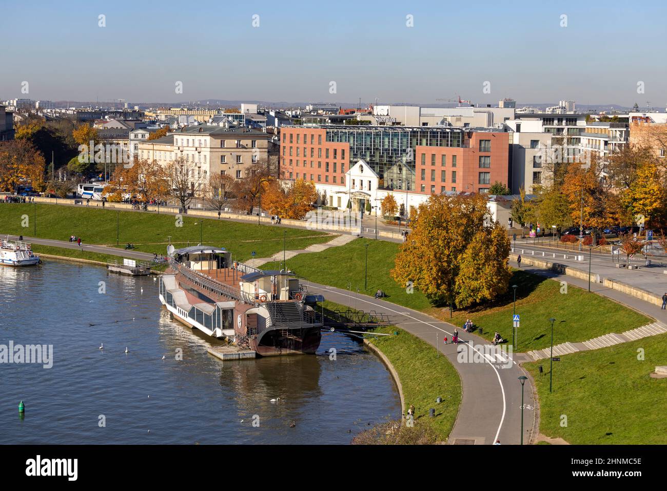 Boulevard on the river Wisla, recreational area, barge restaurant mooring at the shore, Krakow, Poland Stock Photo