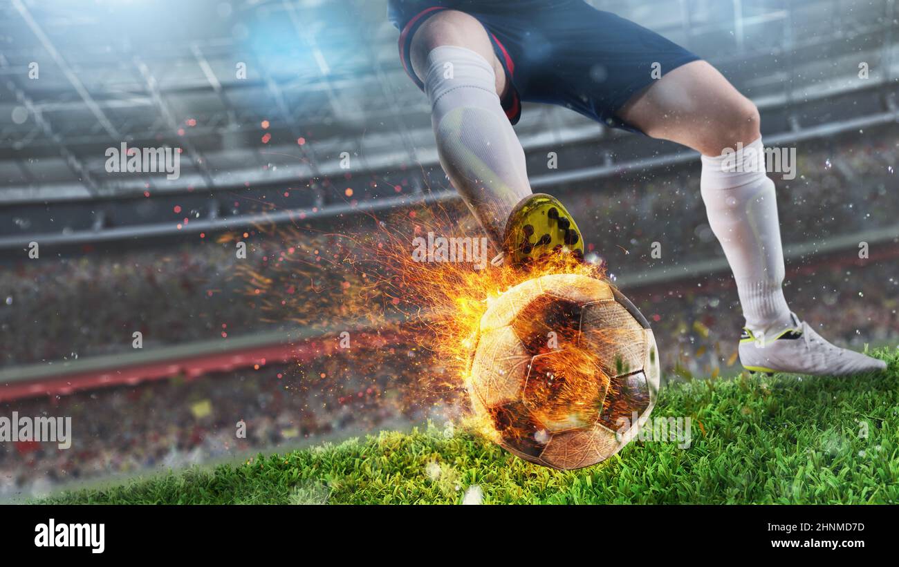 Powerful kick of a soccer player with fiery ball in the stadium Stock