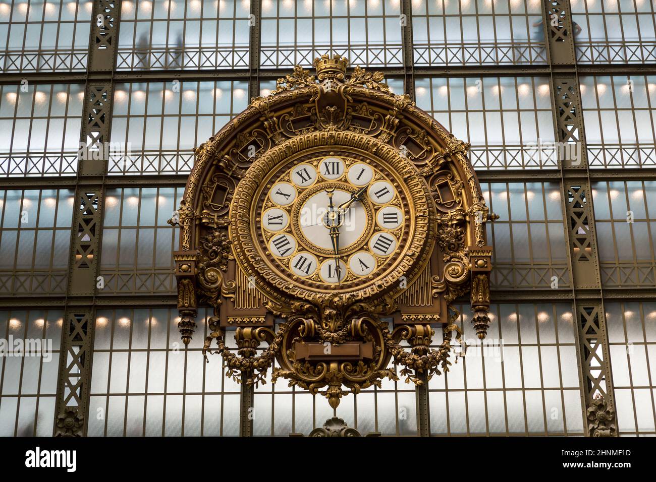 PARIS -SEPTEMBER 7, 2014: Golden clock of the museum D'Orsay in Paris, France. Musee d'Orsay has the largest collection of impressionist and post-impressionist paintings in the world. Stock Photo