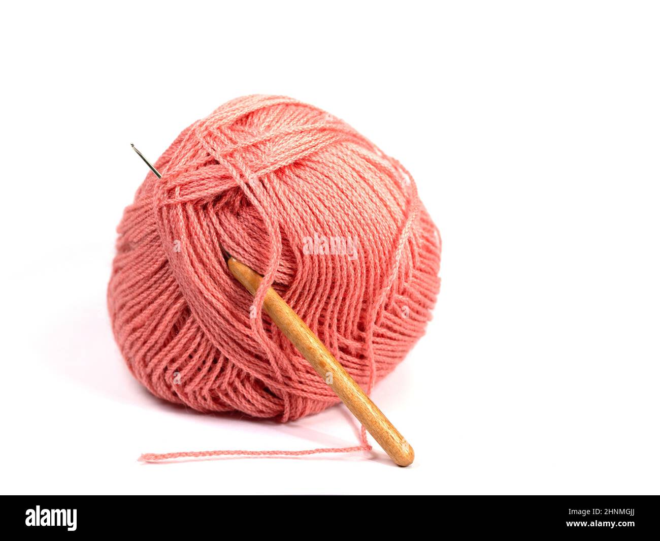 Red crochet yarn against white background Stock Photo