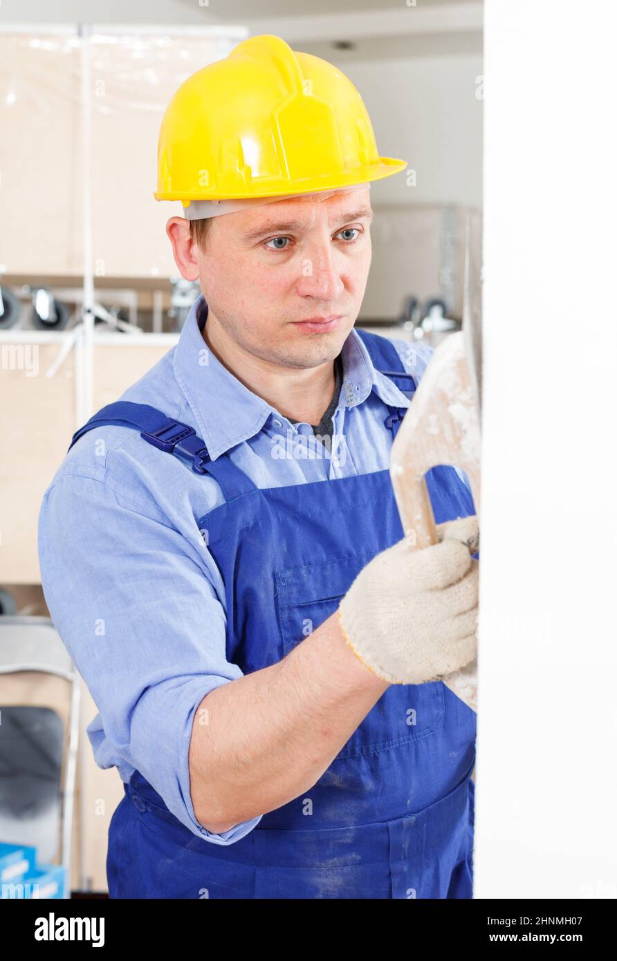 Plasterer working indoors Stock Photo