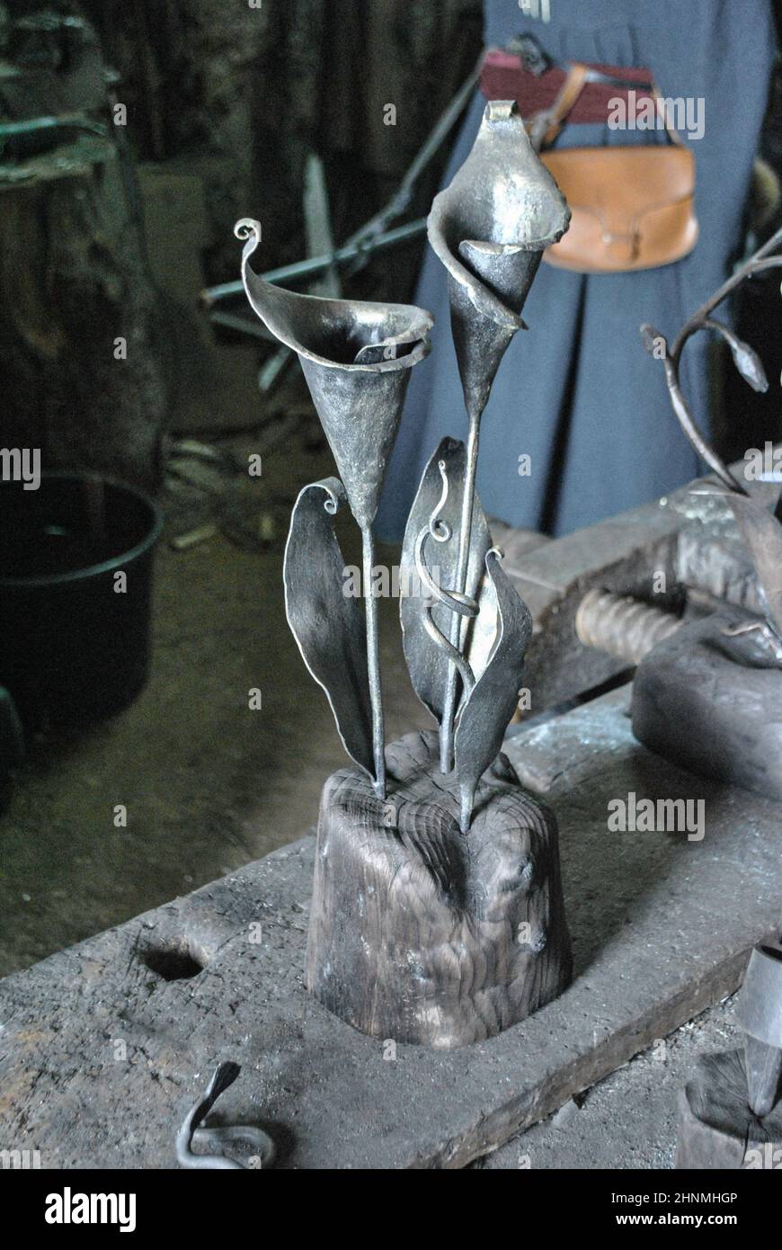 In the workshop at the blacksmith's flower calla forged from metal, close-up Stock Photo