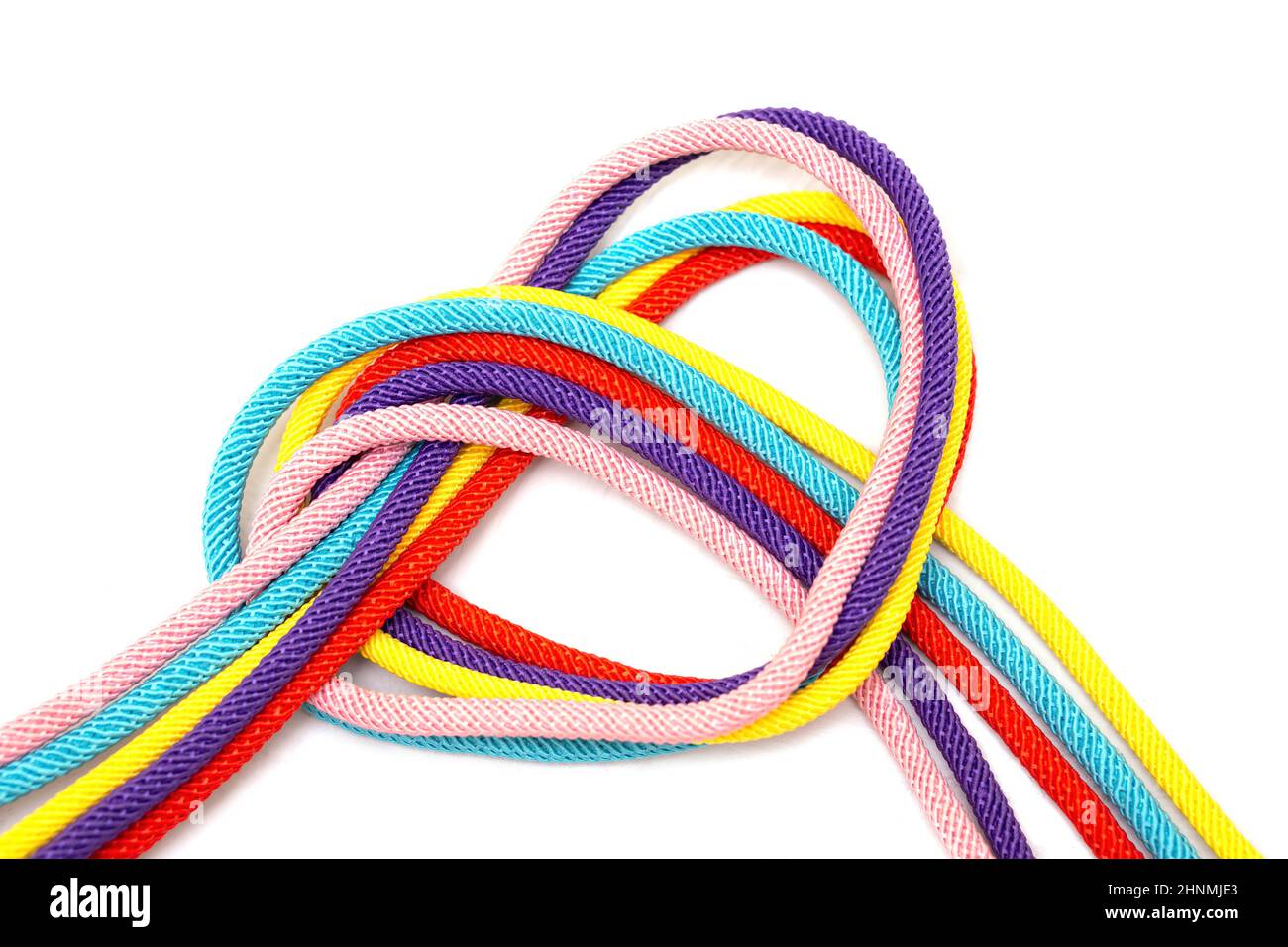 Heart shaped made of five multicolored cords tied together isolated on white background. Community integration concept. Stock Photo