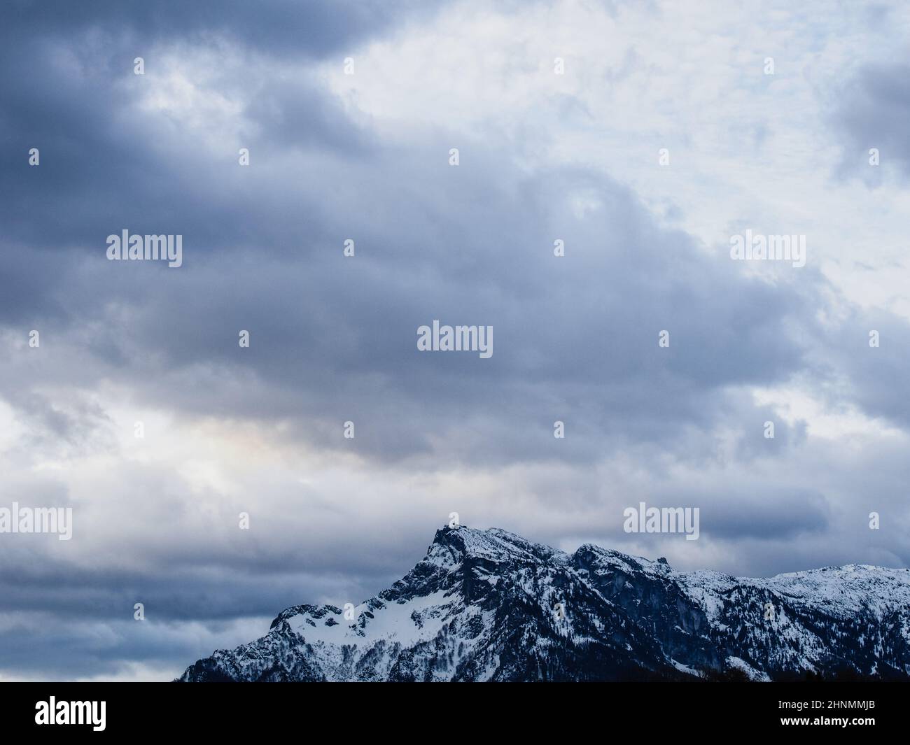 Snowy Mountain and dramatic sky / Schneebedeckter Berg und dramatischer Himmel Stock Photo