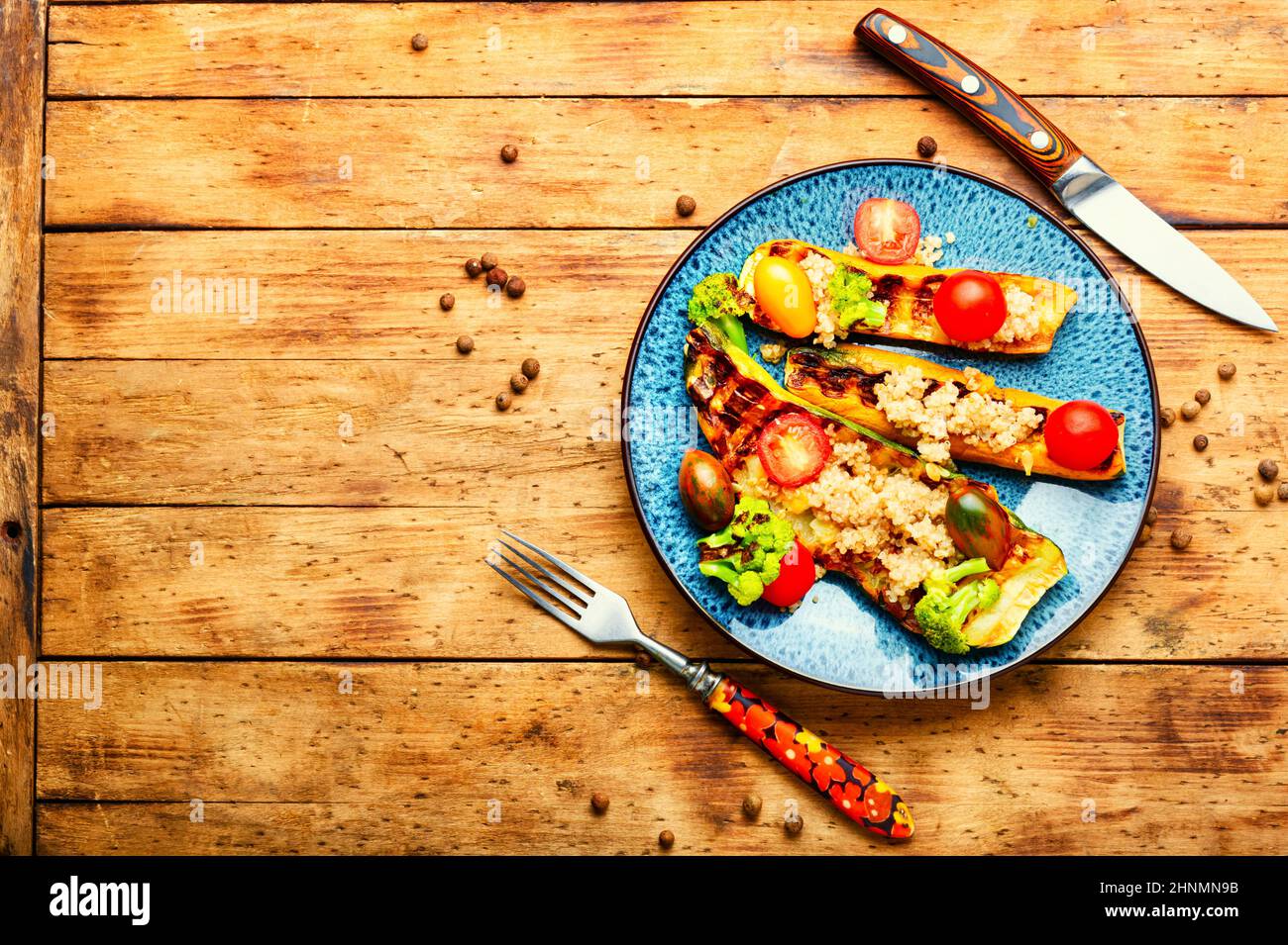 Vegan food made from grilled zucchini stuffed with quinoa and