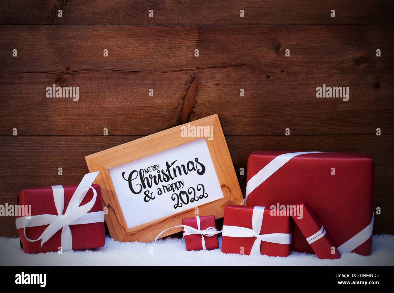 Red Frames 2022 Christmas Picture Frame With English Calligraphy Merry Christmas And A Happy 2022. Red  Christmas Gift And Present. Wooden Background With Snow Stock Photo - Alamy